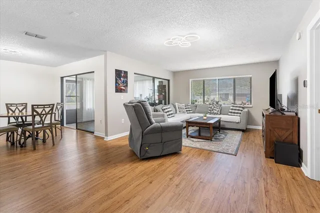a living room with furniture dining room and wooden floor