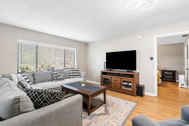 a living room with furniture a rug and a large window