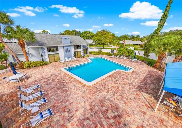 a view of house with yard and outdoor seating