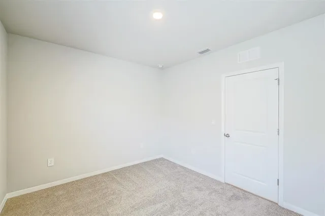 an empty room with closet area