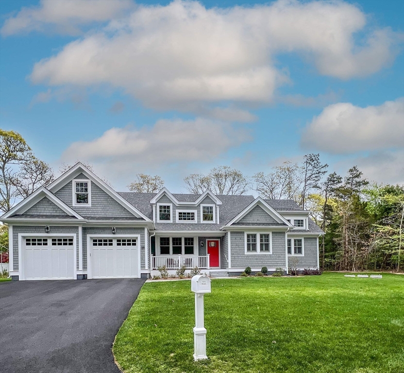 a view of house with yard and green space
