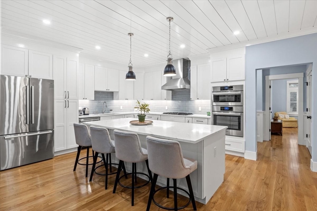 36 Ralyn Road Barnstable, MA 02635 - Photo 23 of 39 a kitchen with stainless steel appliances kitchen island granite countertop a dining table chairs and wooden floor