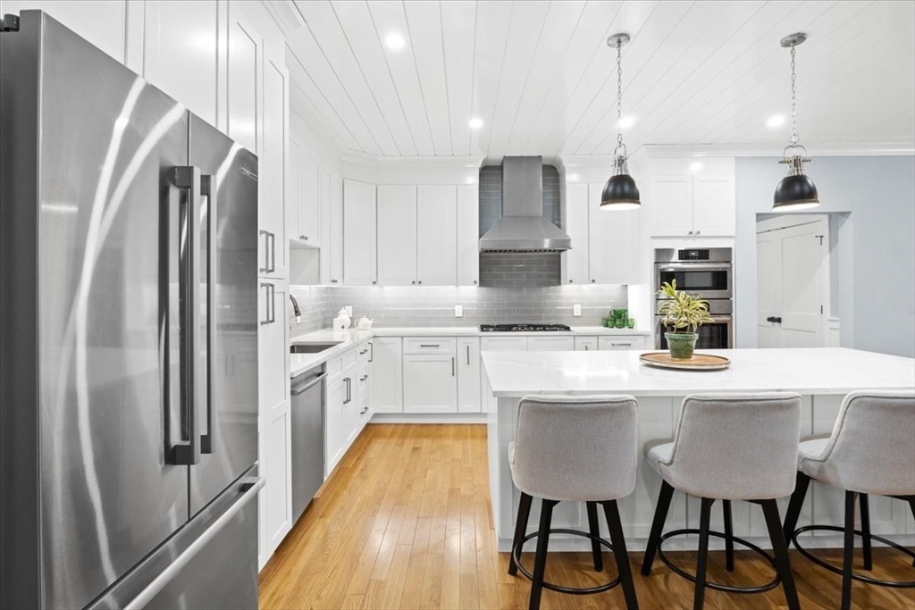 36 Ralyn Road Barnstable, MA 02635 - Photo 24 of 39 a kitchen with stainless steel appliances granite countertop a sink a stove a refrigerator and island with wooden floor