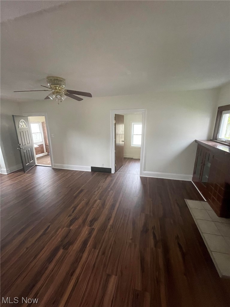 2406 Lake Rd Boulevard Northwest Canton, OH 44708 - Photo 5 of 12 Unfurnished living room featuring ceiling fan and dark hardwood / wood-style floors