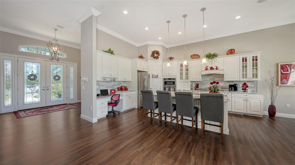 20 Bayhead Lane Osprey, FL 34229 - Photo 11 of 72 a living room with kitchen island furniture wooden floor and a chandelier
