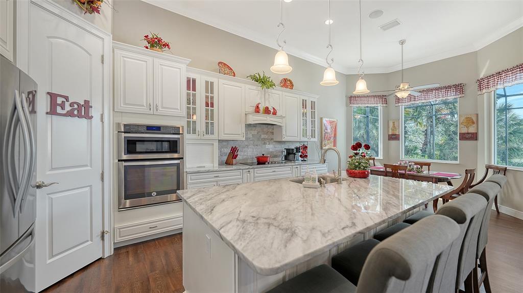 20 Bayhead Lane Osprey, FL 34229 - Photo 13 of 72 a kitchen with stainless steel appliances granite countertop a sink a refrigerator and a stove