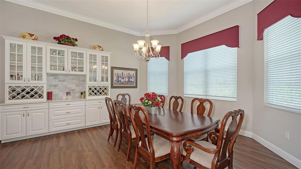 20 Bayhead Lane Osprey, FL 34229 - Photo 16 of 72 a view of a dining room with furniture window and wooden floor