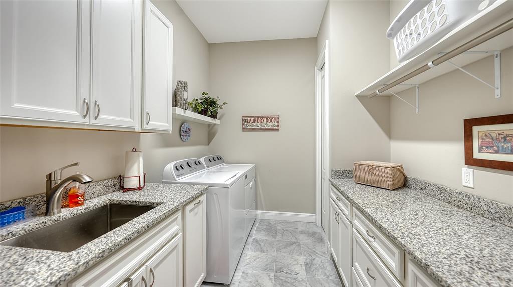 20 Bayhead Lane Osprey, FL 34229 - Photo 33 of 72 a kitchen with stainless steel appliances granite countertop a sink and a stove