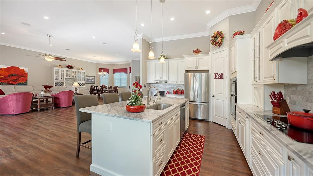 20 Bayhead Lane Osprey, FL 34229 - Photo 5 of 72 a kitchen that has a lot of cabinets a sink and wooden floor