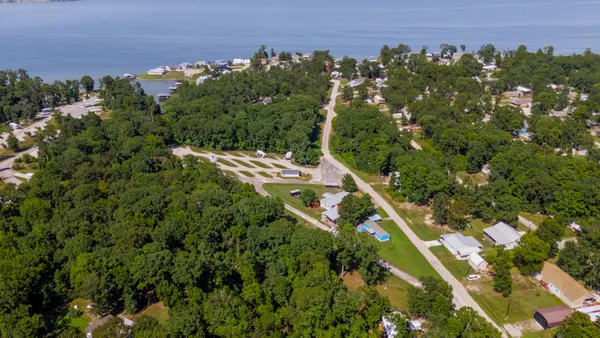 an aerial view of a house with a yard