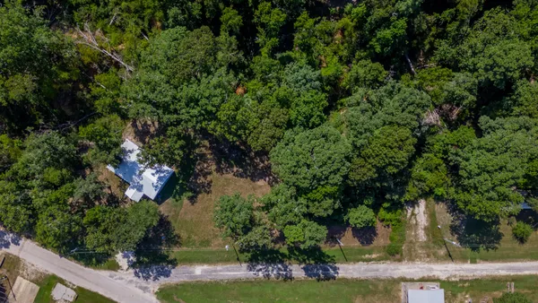 an aerial view of a house with yard