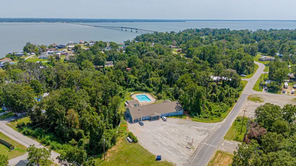 an aerial view of a house with a yard and lake view