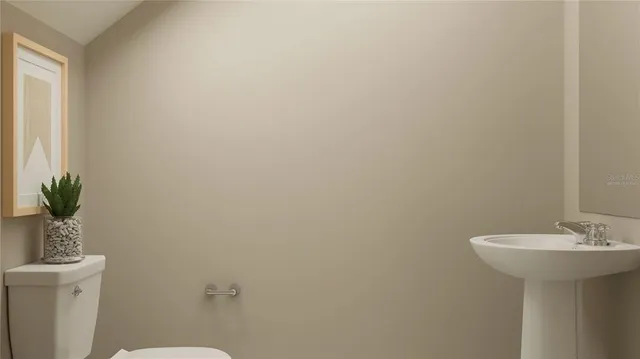 a bathroom with a sink toilet and a mirror