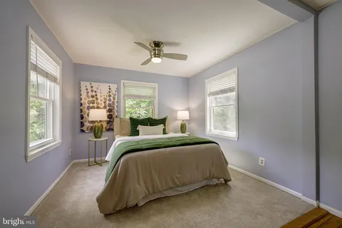 a bed sitting in a bedroom next to a window