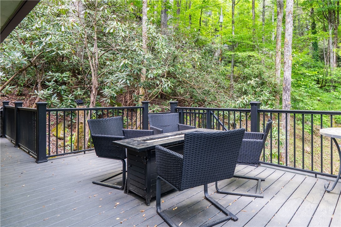 141 Snowflake Road Banner Elk, NC 28604 - Photo 24 of 28 a view of a balcony with wooden floor and outdoor seating