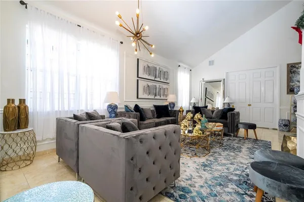 a living room with furniture and a wooden floor
