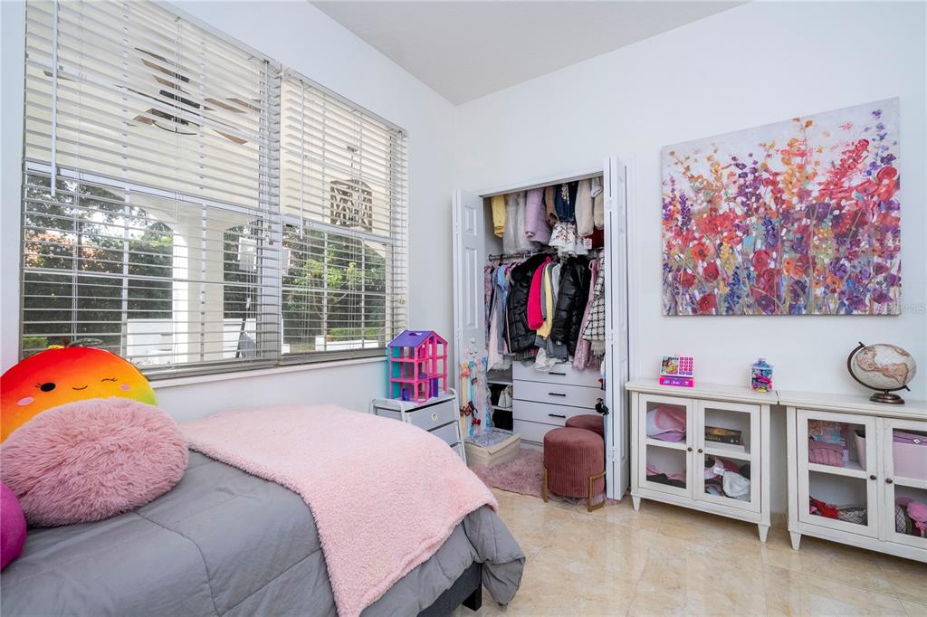 11410 Rapallo Lane Windermere, FL 34786 - Photo 27 of 62 a bedroom with a bed and a book shelf