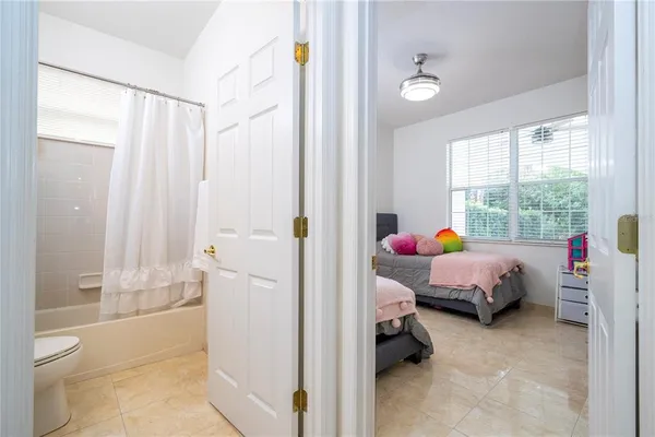 a spacious bathroom with a sink double vanity granite tub shower and a mirror
