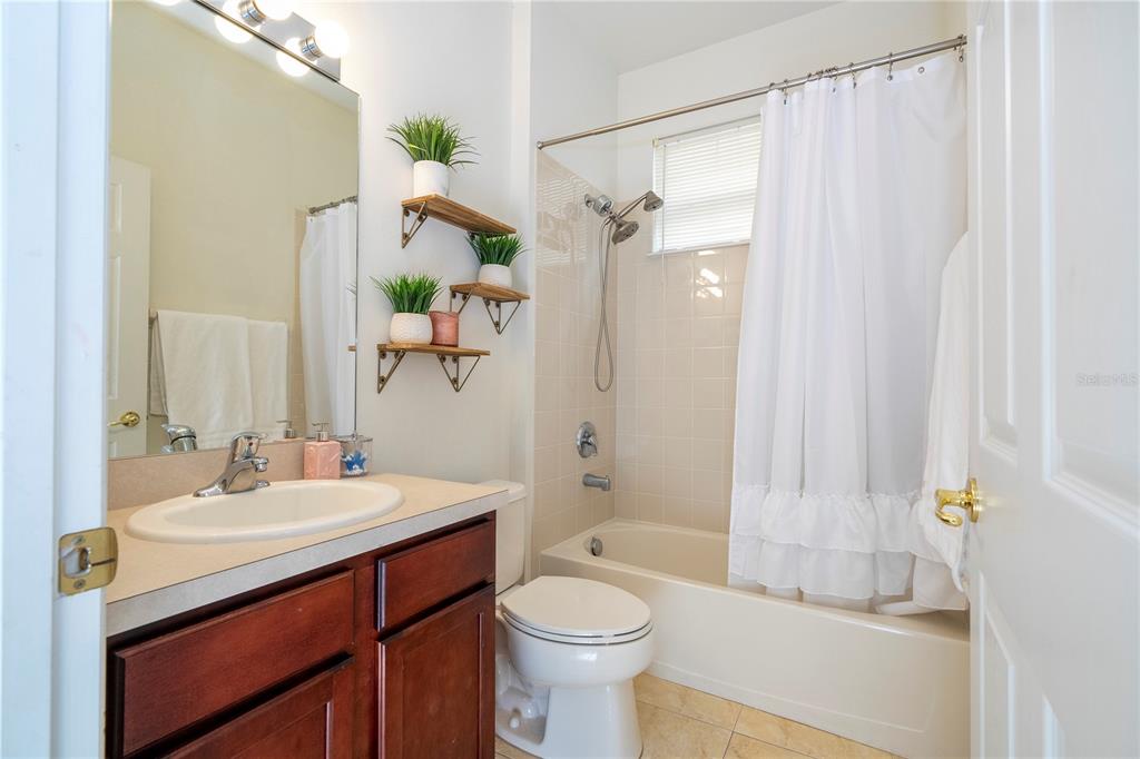 11410 Rapallo Lane Windermere, FL 34786 - Photo 29 of 62 a bathroom with a sink a toilet and shower curtain