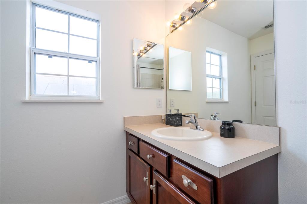11410 Rapallo Lane Windermere, FL 34786 - Photo 39 of 62 a bathroom with a sink and a mirror