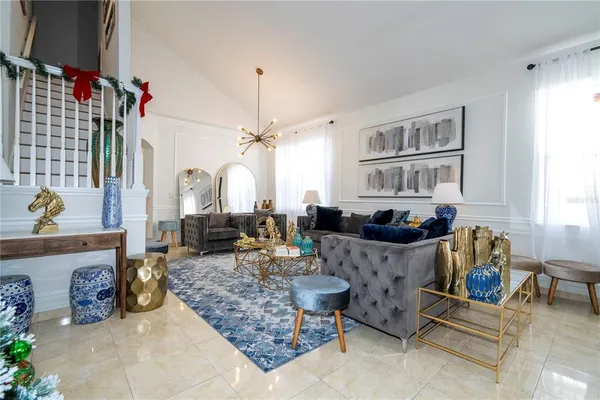 a living room with furniture window and wooden floor
