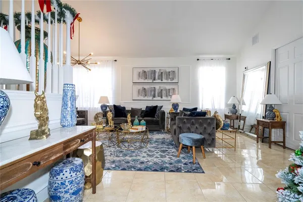a living room with furniture and flowers