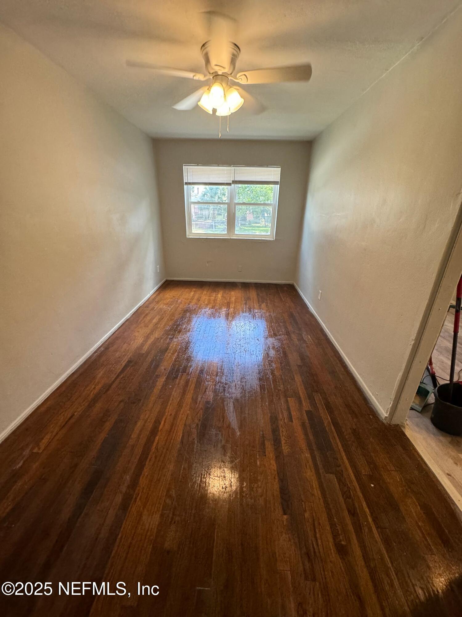 2117 Spring Park Road, Unit 1 Jacksonville, FL 32207 - Photo 7 of 9 wooden floor in an empty room with a window
