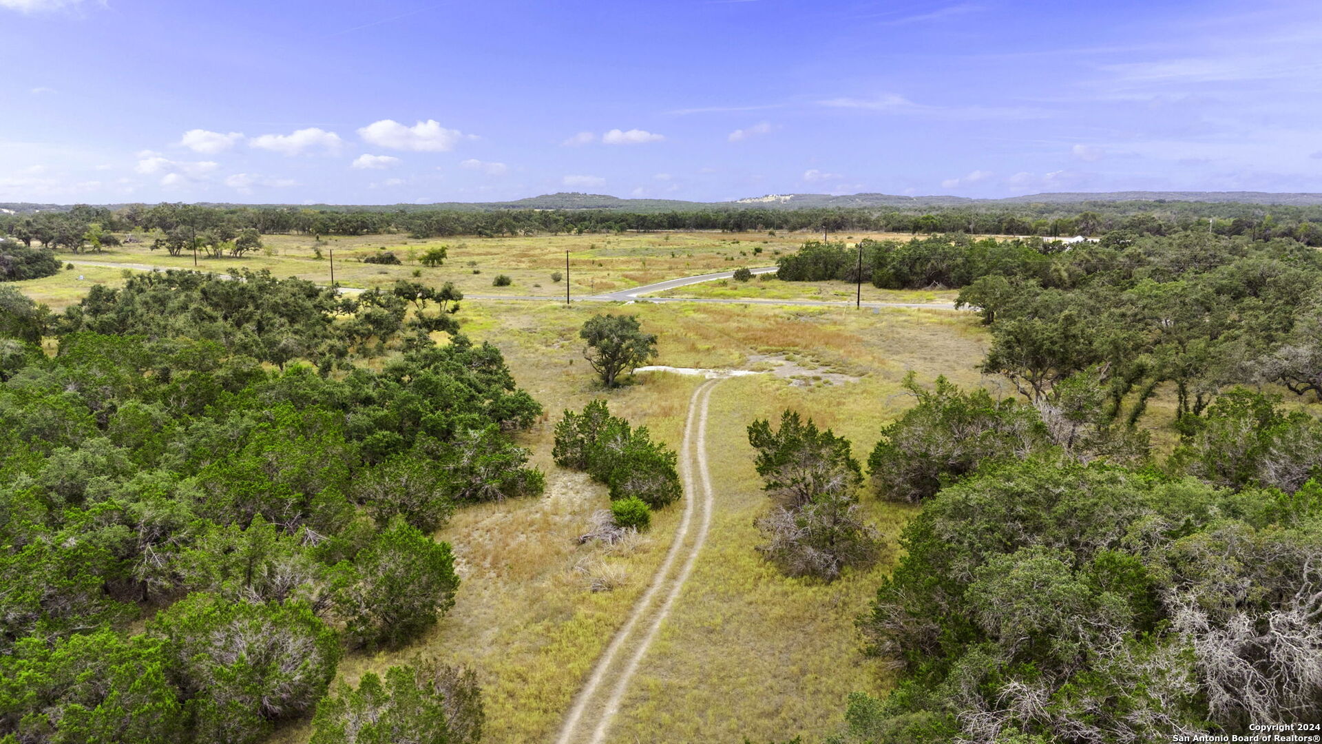 701 Windmill Ridge Blanco, TX 78606 - Photo 14 of 18 a view of lake with sunset