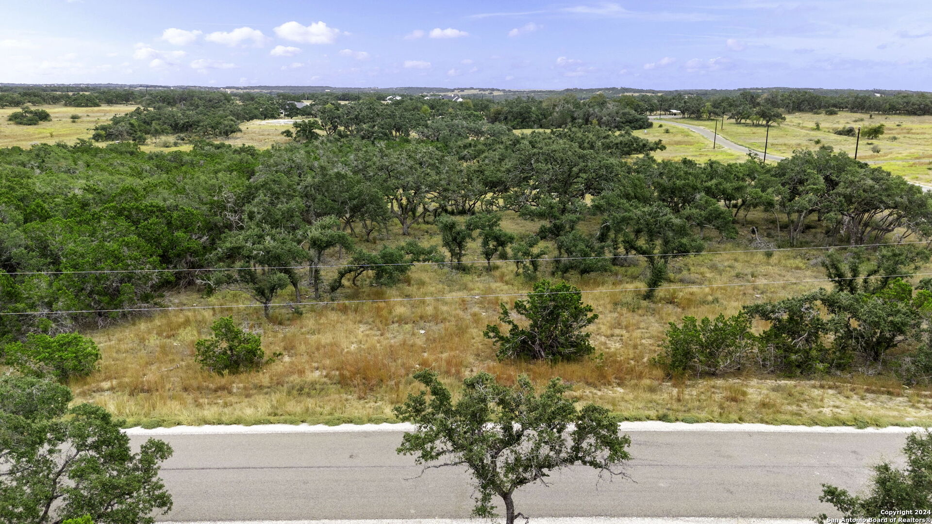701 Windmill Ridge Blanco, TX 78606 - Photo 2 of 18 a view of a lake from a yard