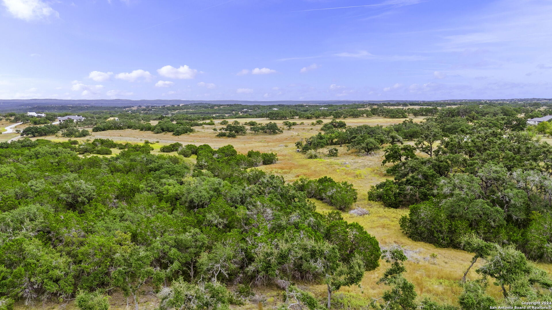 701 Windmill Ridge Blanco, TX 78606 - Photo 10 of 18 a view of a lake with a house in the background