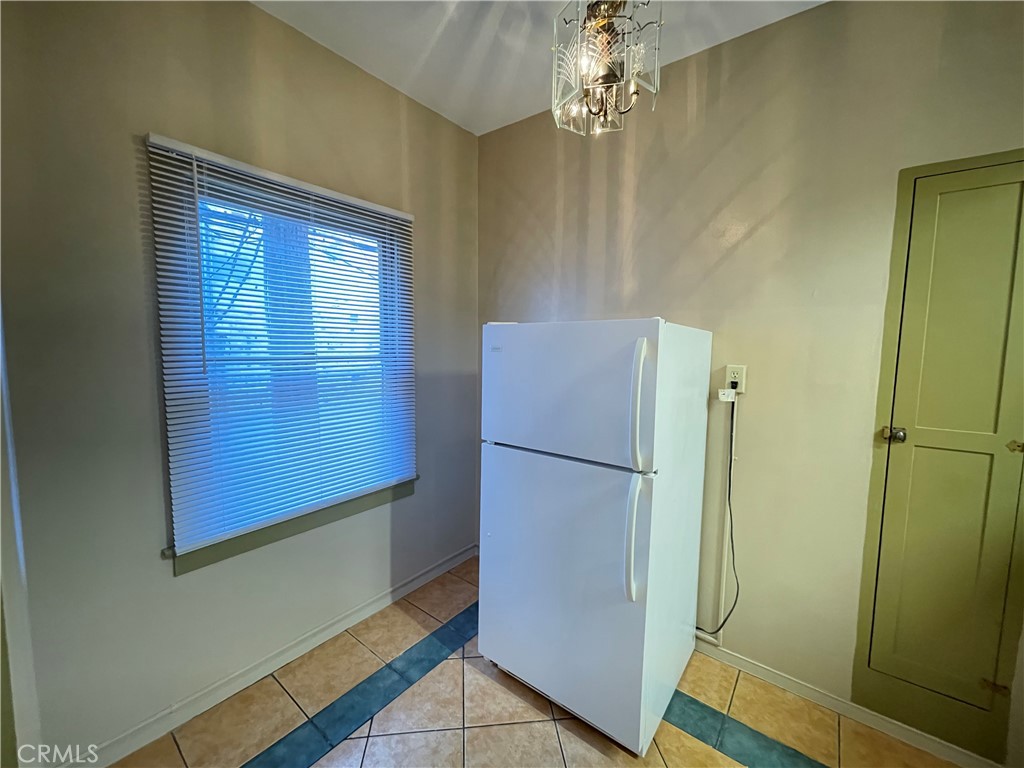 723 East 3rd Street, Unit 12 5 Long Beach, CA 90802 - Photo 5 of 8 a room with a refrigerator and chandelier