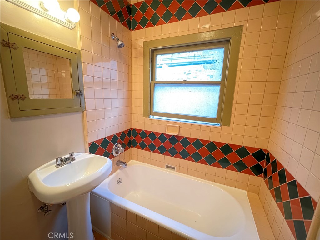 723 East 3rd Street, Unit 12 5 Long Beach, CA 90802 - Photo 8 of 8 a bathroom with a sink and a bathtub