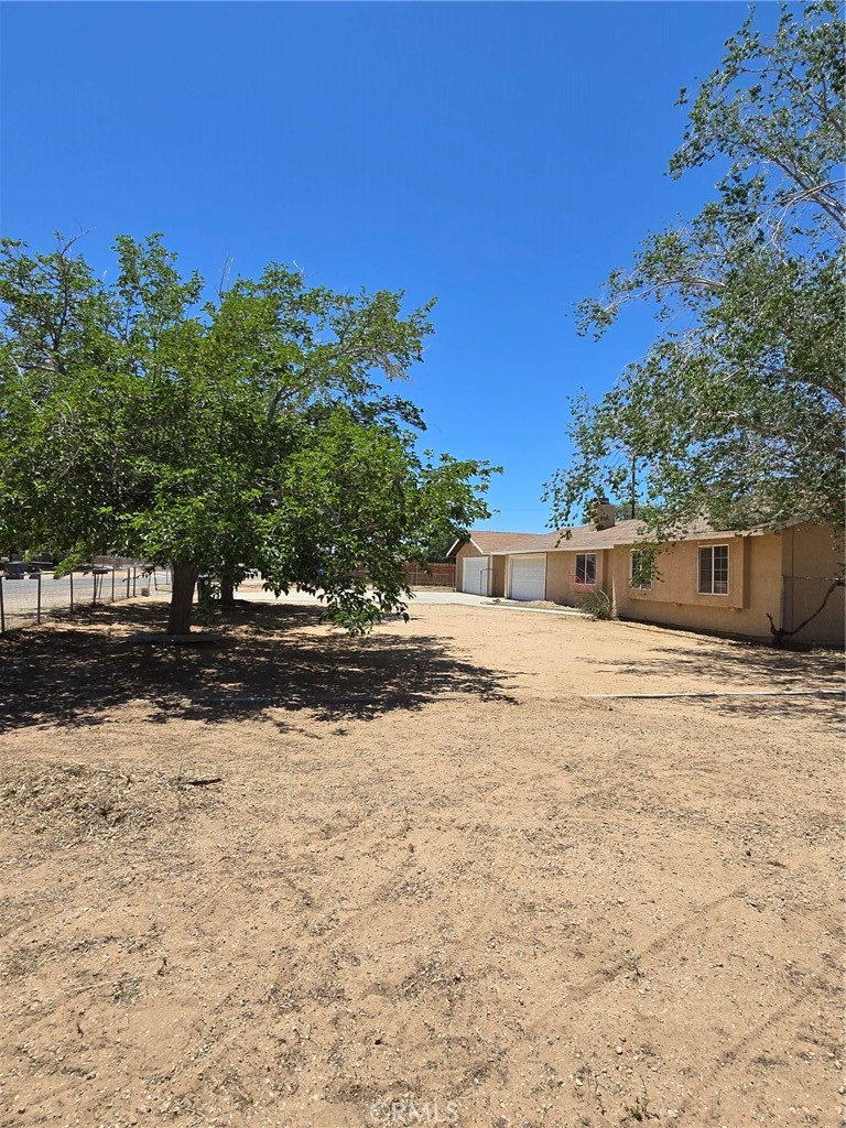 11876 Puye Road Apple Valley, CA 92308 - Photo 3 of 9 a front view of a house with a yard