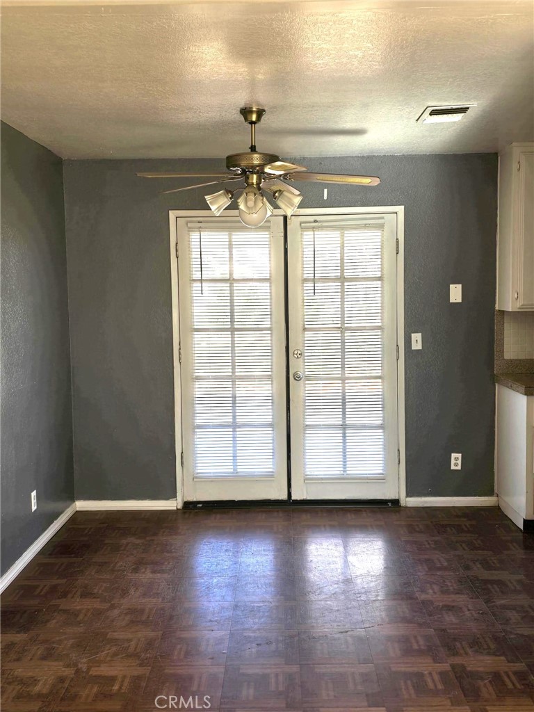 11876 Puye Road Apple Valley, CA 92308 - Photo 6 of 9 an empty room with wooden floor and windows