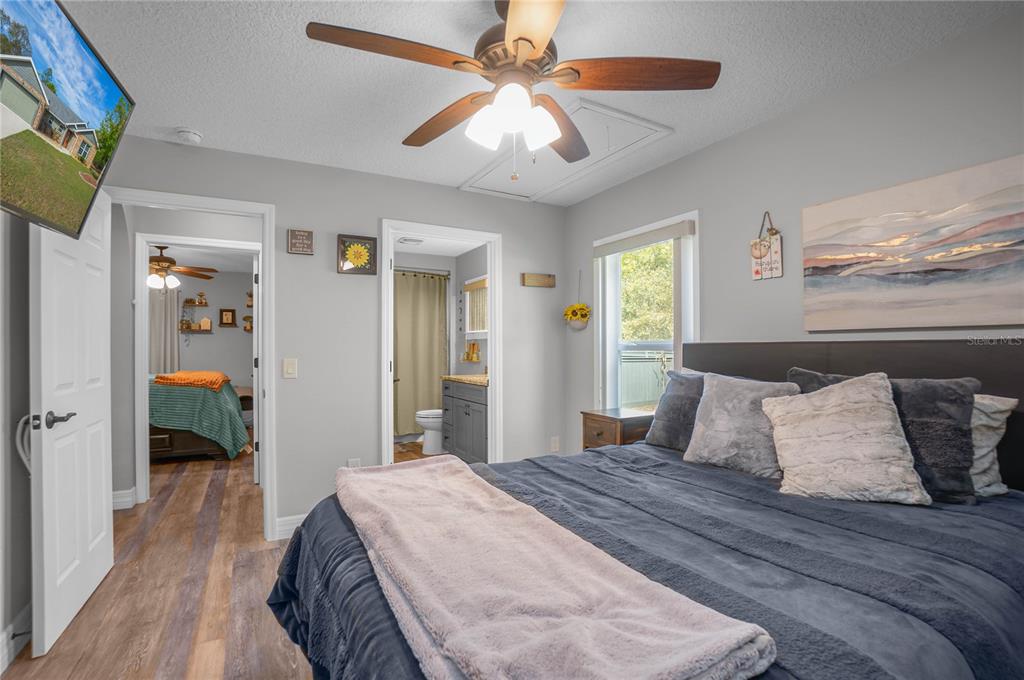 5466 West Tortuga Loop Lecanto, FL 34461 - Photo 25 of 41 a bedroom with a bed and a chandelier