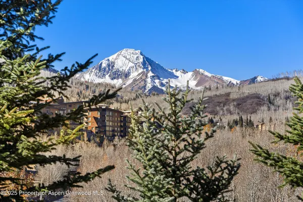 a spacious bedroom with a bed and a large window