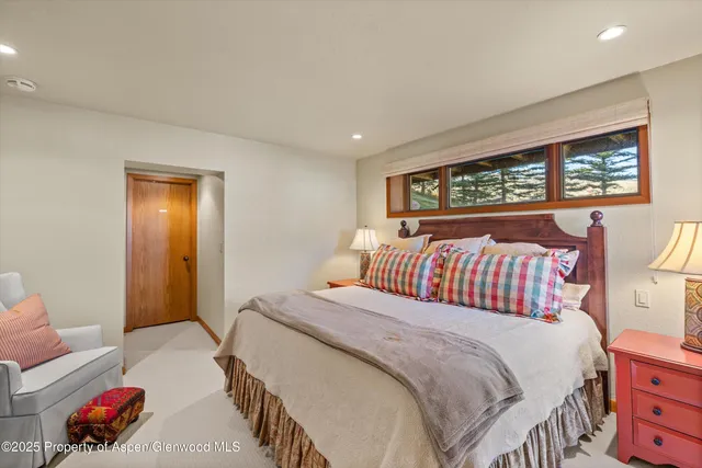a bathroom with a granite countertop tub sink and mirror