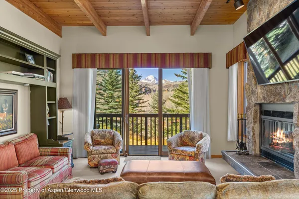 a living room with furniture fireplace and a flat screen tv