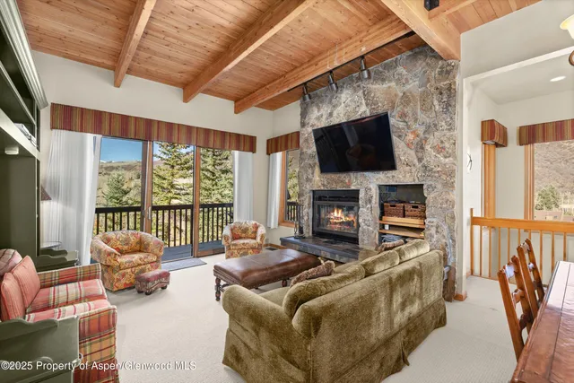 a living room with furniture fireplace and a flat screen tv
