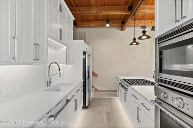 a kitchen with a sink stove and cabinets