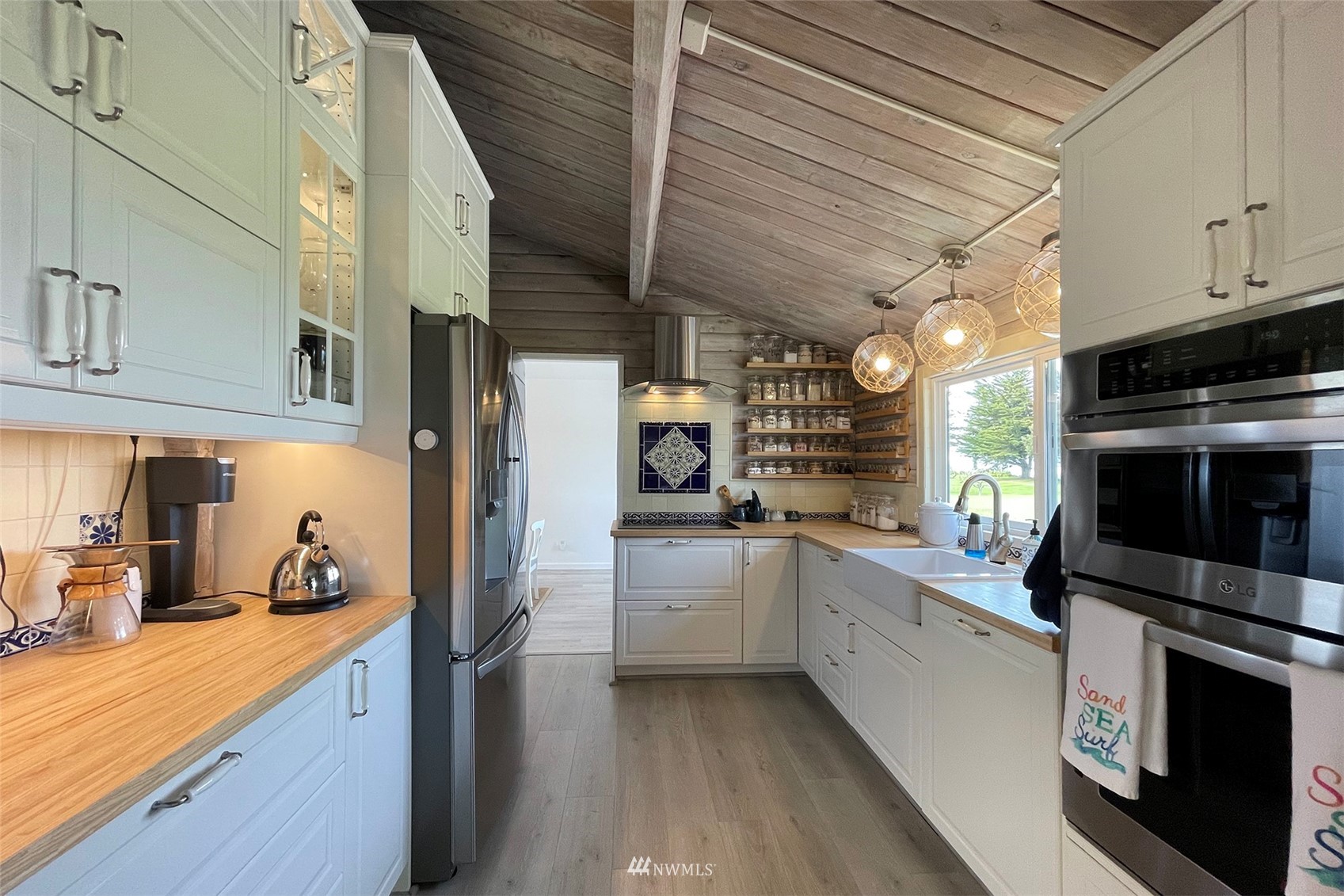 622 West Anderson Road Sequim, WA 98382 - Photo 14 of 40 a kitchen with white cabinets and appliances