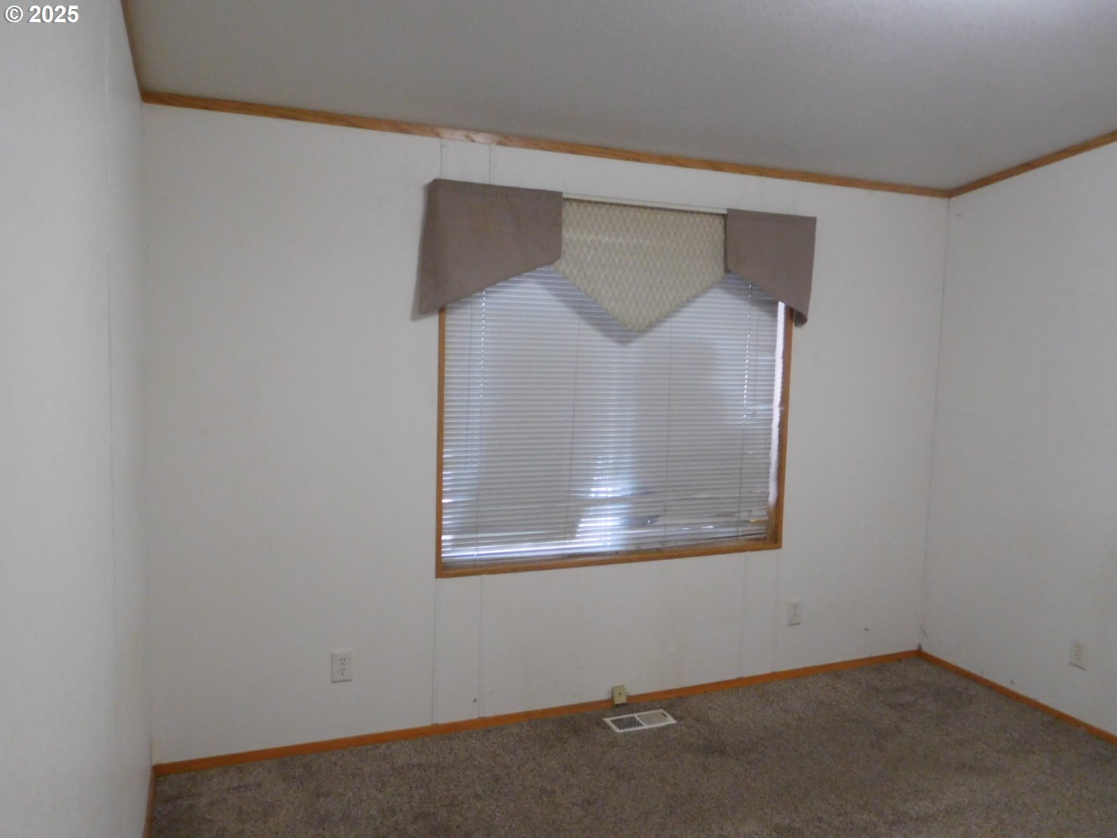 1437 Southwest 37th Street, Unit 43 Pendleton, OR 97801 - Photo 18 of 21 an empty room with wooden floor and cabinet