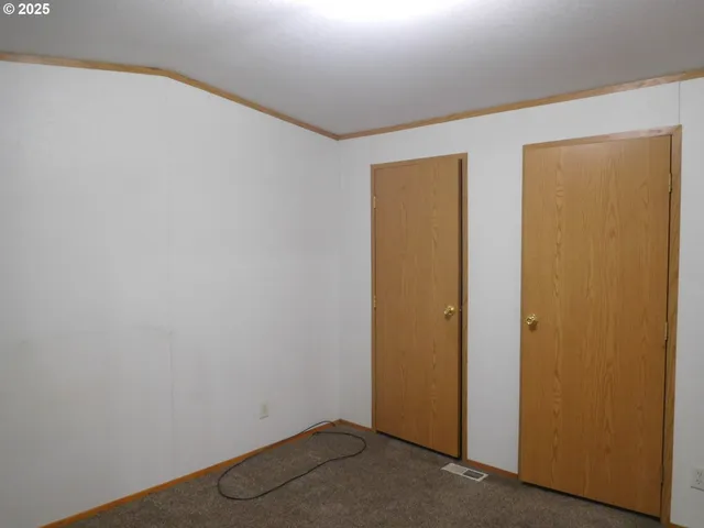 a view of an empty room with chair