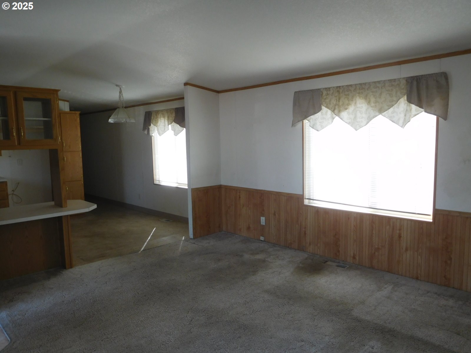 1437 Southwest 37th Street, Unit 43 Pendleton, OR 97801 - Photo 9 of 21 a view of an empty room with a fireplace and a window