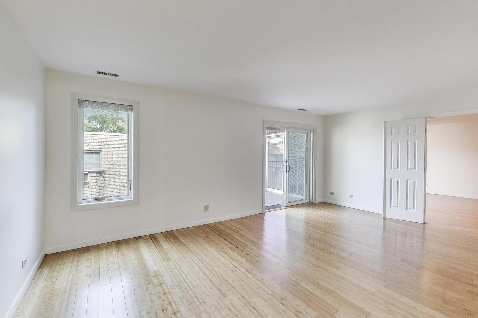 2720 Central Street, Unit 4C Evanston, IL 60201 - Photo 12 of 25 an empty room with wooden floor and windows