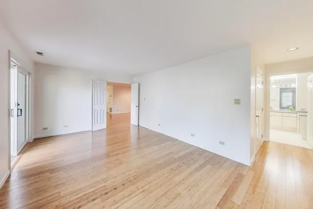 a view of an empty room and wooden floor