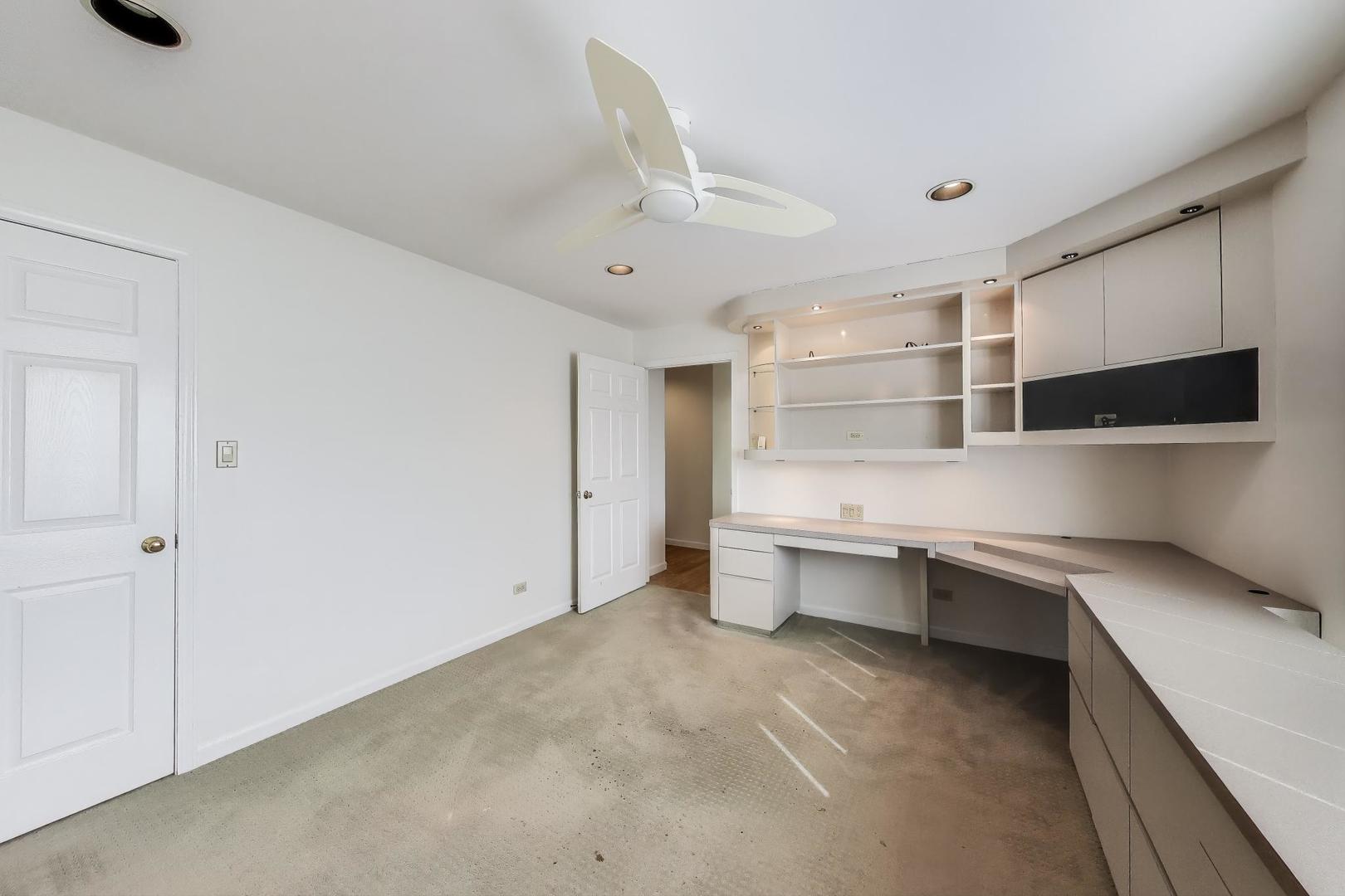 2720 Central Street, Unit 4C Evanston, IL 60201 - Photo 17 of 25 a large white kitchen with a sink and dishwasher a stove top oven with wooden floor