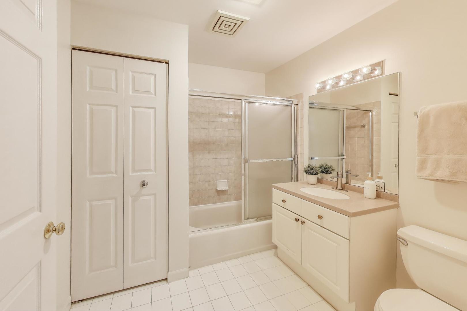 2720 Central Street, Unit 4C Evanston, IL 60201 - Photo 20 of 25 a bathroom with a double vanity sink toilet and shower