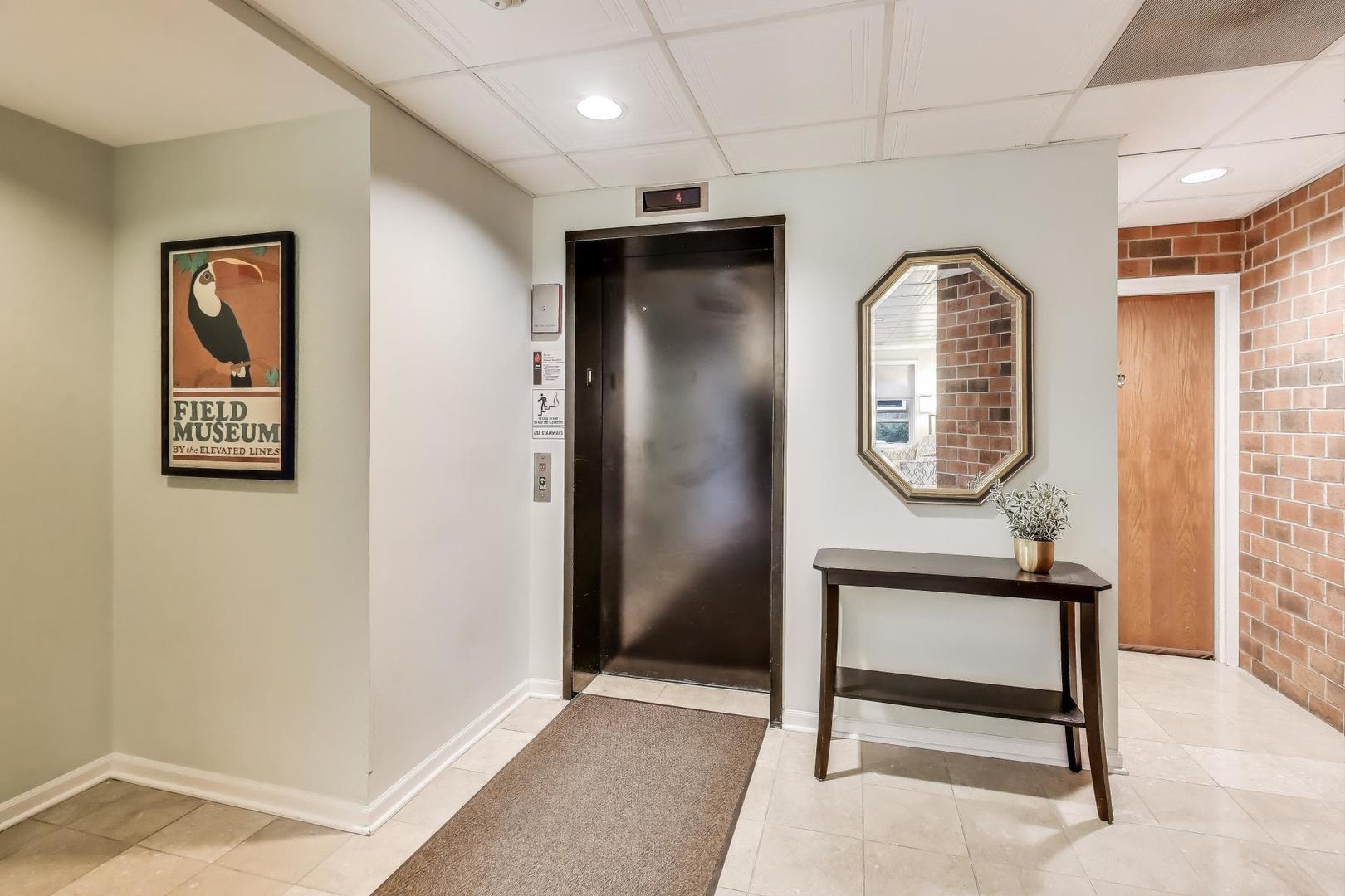 2720 Central Street, Unit 4C Evanston, IL 60201 - Photo 4 of 25 a view of a hallway with paintings on the wall