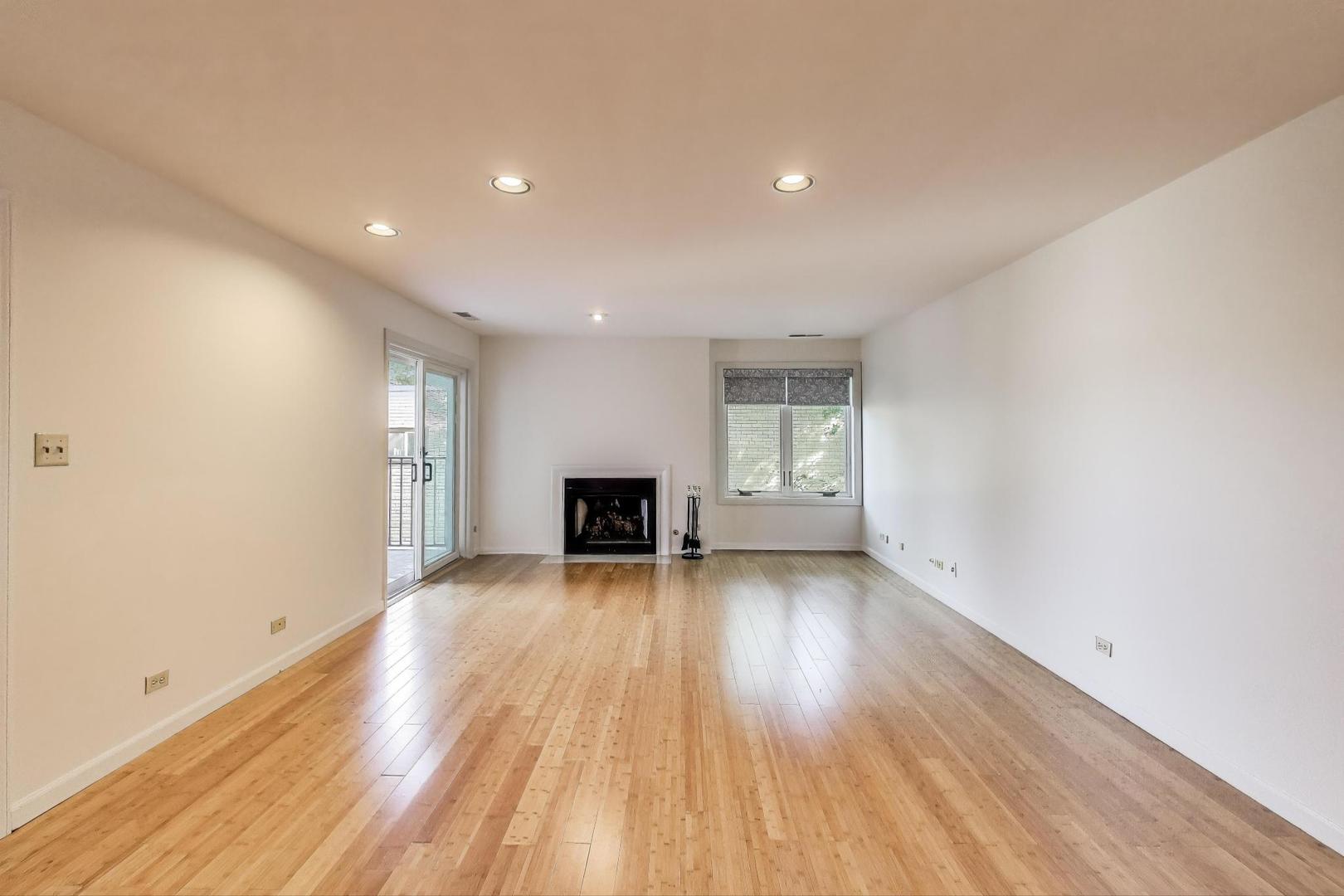 2720 Central Street, Unit 4C Evanston, IL 60201 - Photo 5 of 25 a view of an empty room with wooden floor and a window